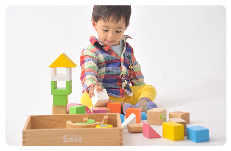 カラフルな積み木（つみき）で遊ぶ赤ちゃん